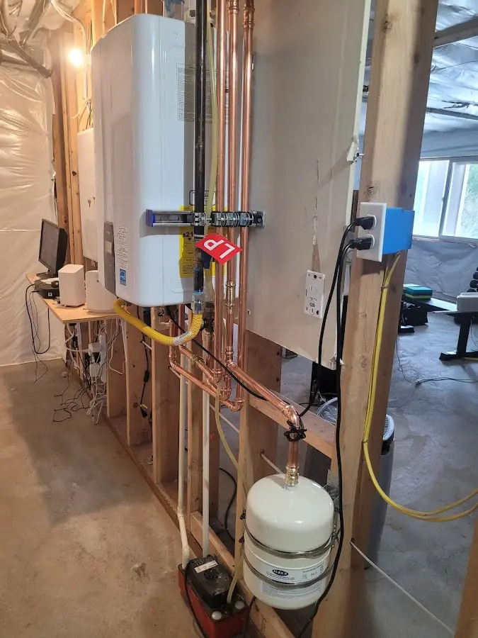 Licensed plumber repairing a kitchen sink in Raynham
